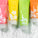 The image features a vibrant lineup of Tropic Body Washes, each in brightly colored packaging with botanical designs. The tubes are partially submerged in cascading water, emphasizing their refreshing and hydrating qualities. The visible scents include:
Jasmine, Neroli and Vetiver (pink).
Frangipani, Star Anise and Tiaré Flower (yellow).
Wild Mint, Lime and Pineapple (green).
Mangosteen, Thyme and Mandarin (orange).
Each body wash is pH-balanced, highlighting their gentle yet effective cleansing properties